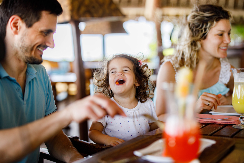 family eating dinner on beach vacation