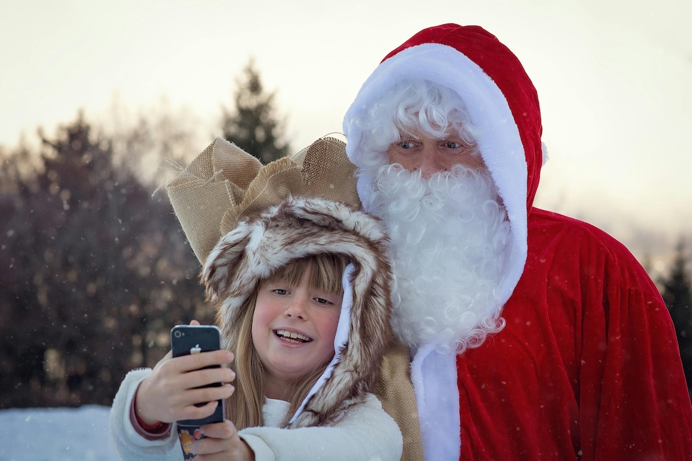 Young girl taking a picture with santa