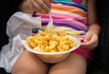 Child eating macaroni and cheese