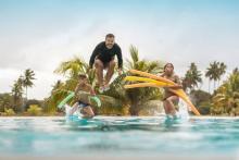 family jumping into pool at vacation rental